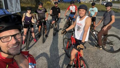 Cyclists in a parking lot.